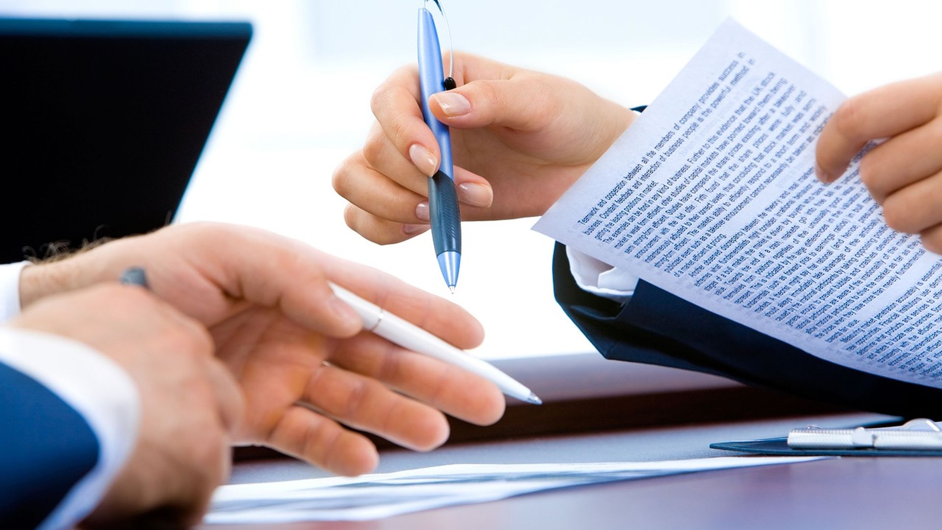 Hands reviewing a signed agreement