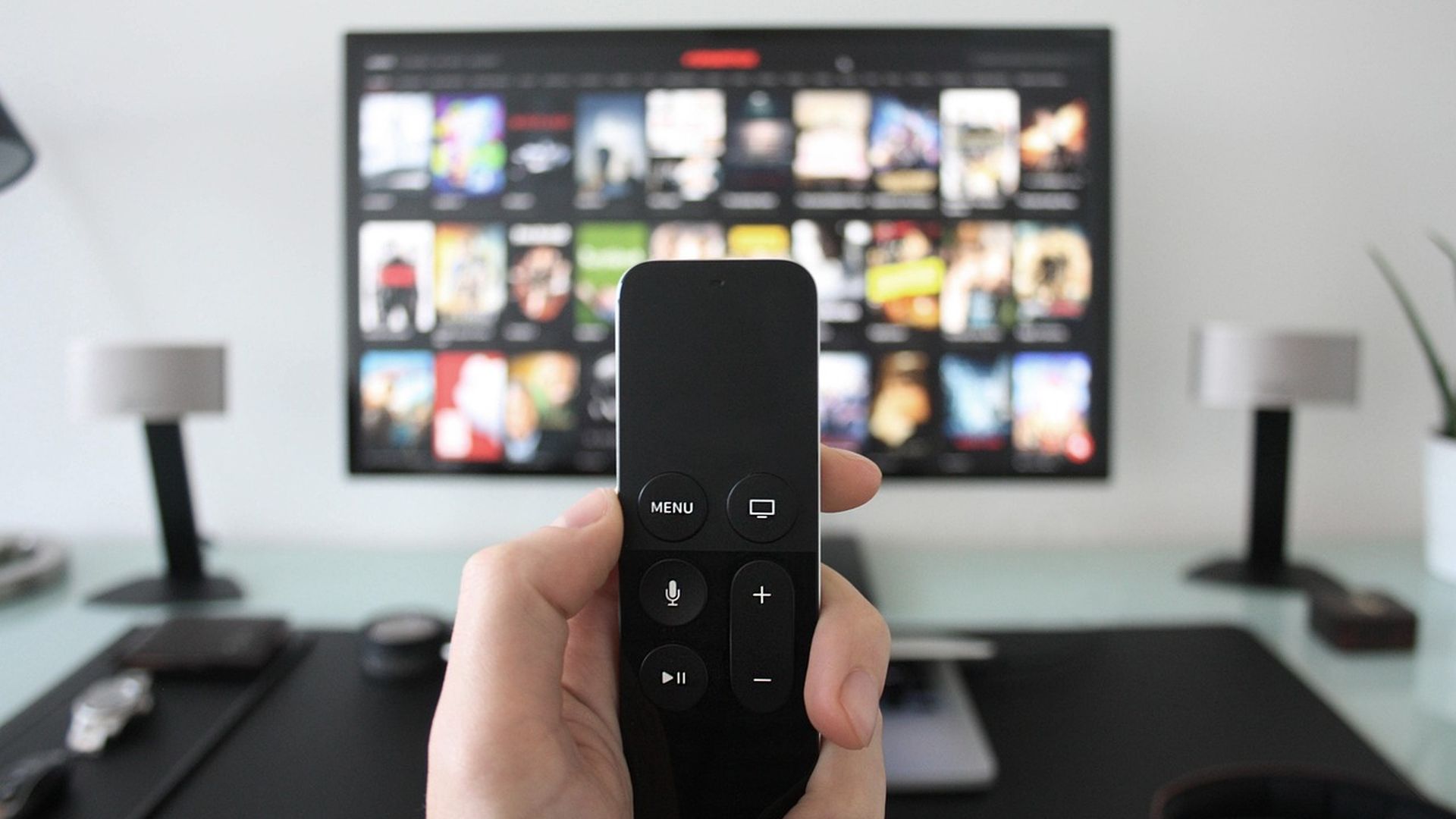 Remote control in front of a streaming screen